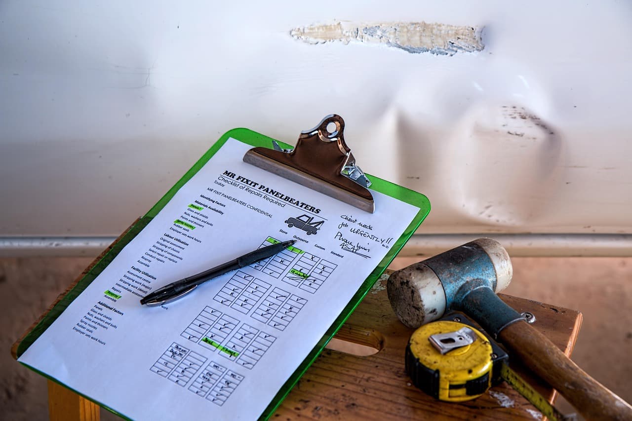 A vehicle inspection sheet on a clipboard, ticked off in pen